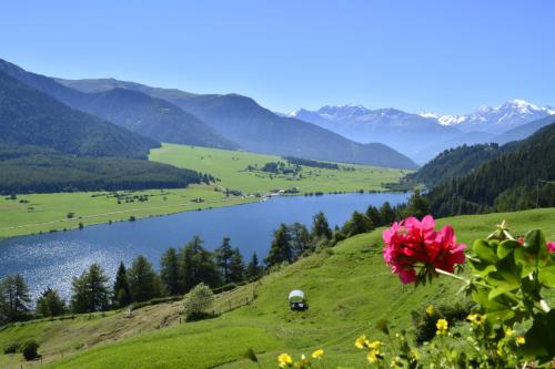 a view of a valley with a lake and mountains at Berghotel Plagött in San Valentino alla Muta
