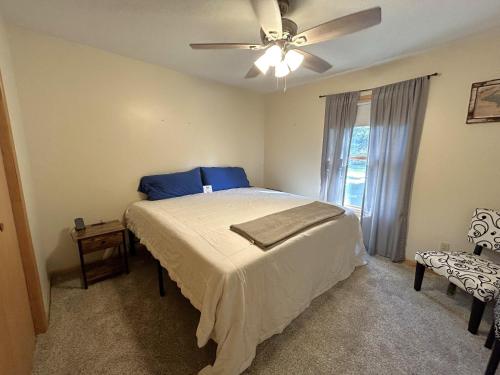 a bedroom with a bed and a ceiling fan at North Country Retreat in Saint Ignace