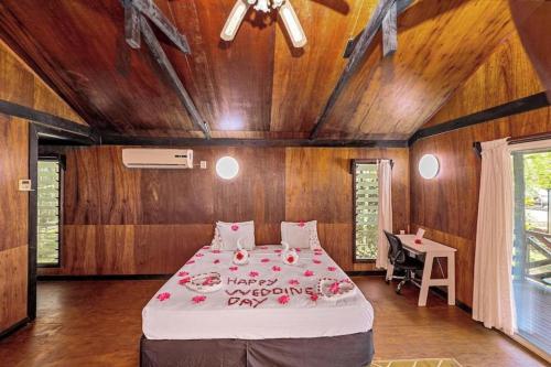 a bedroom with a large bed with flowers on it at Orator Hotel in Siusega