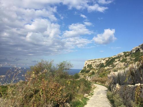 a path on the side of a mountain at Dar tal-Kaptan Boutique Maison in Għasri