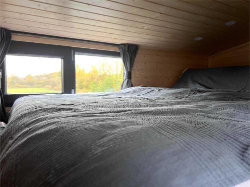 a large bed in a room with a window at Ridge Hill X by Tiny Away in Swanley Junction