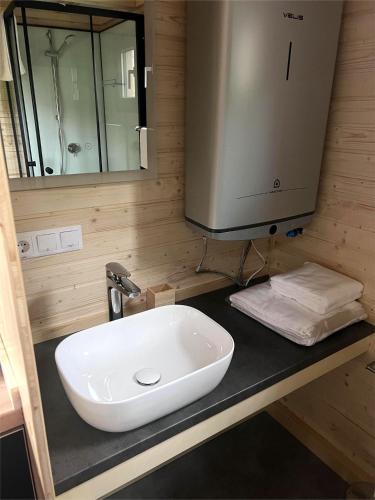 a bathroom with a white sink and a mirror at Ridge Hill X by Tiny Away in Swanley Junction