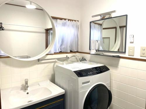 un bagno con lavatrice e lavandino di Village Misaki a Misaki