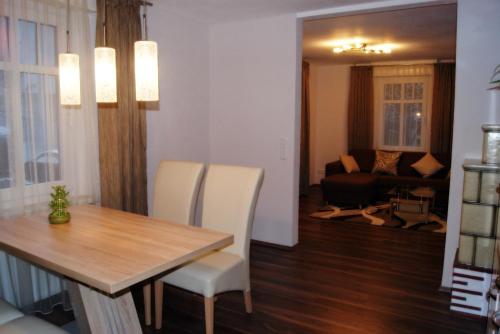 a dining room with a table and chairs and a living room at Haus Rosegger in Feldkirch