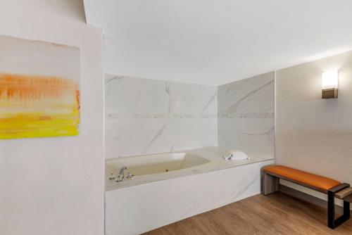 a bathroom with a tub and a painting on the wall at Comfort Inn & Suites Ormond Beach Oceanfront in Ormond Beach
