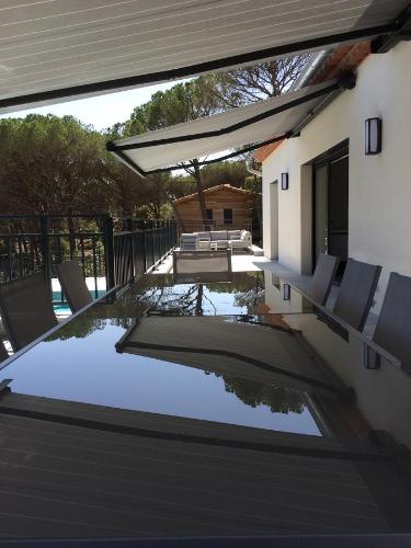 a patio with chairs and a swimming pool at Villa Terre des Maures in Vidauban