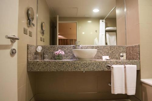 a bathroom with a sink and a mirror at LRH Calama, an Ascend Collection Hotel in Calama