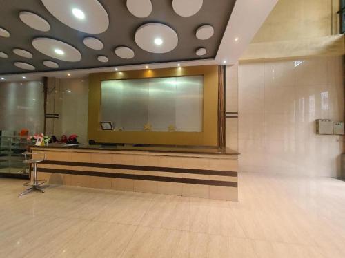 a lobby with a large mirror on the wall at Hotel Bintang in Kisaran