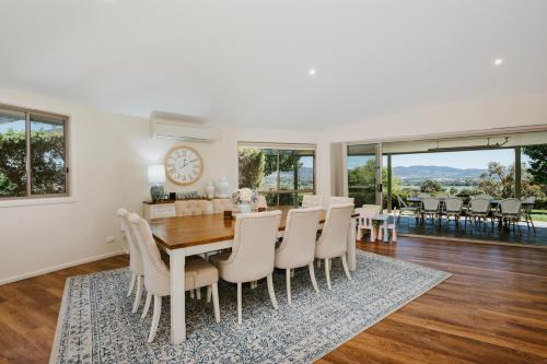 a dining room with a table and chairs at Allambie - Poolside Elegance in Mudgee Countryside in Mudgee
