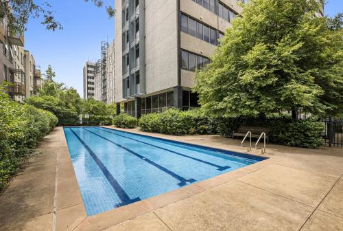 an empty swimming pool in front of a building at Studio Apartment near CBD, RMIT & Uni of Melbourne in Melbourne