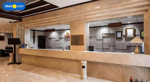 a lobby of a hotel with a reception counter at Regent's Park Hotel in Malang