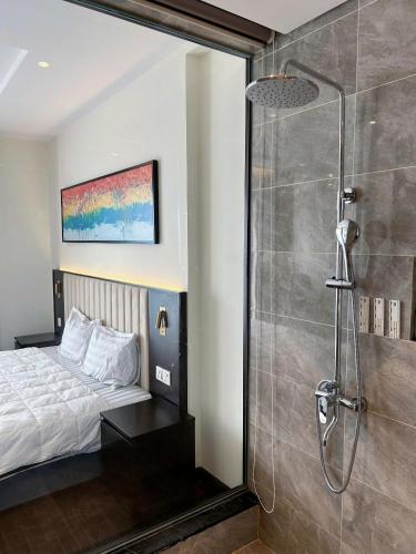a bedroom with a bed and a shower in a room at Sapphire home S2 in Ha Long