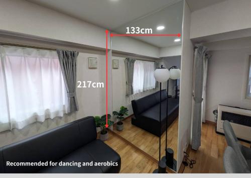 a living room with a couch and a room with at CleanNest Hokkaido Sapporo Kita33jyou in Sapporo