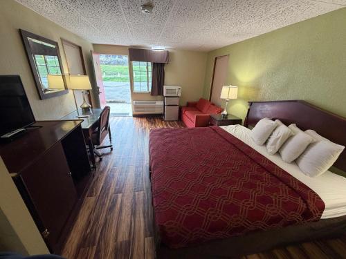 a hotel room with a large bed and a desk at Kiteville Bradford in Bradford