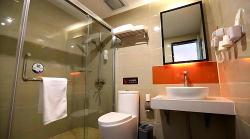 a bathroom with a sink and a toilet and a shower at 7 Days Premium·Jining Yanzhou Sun Fortune Plaza in Yanzhou