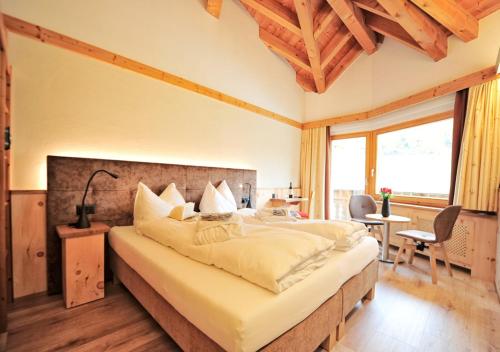 a bedroom with a large bed in a room at Country Wellnesshotel Bündnerhof in Samnaun