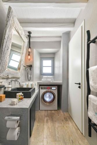 a bathroom with a washing machine and a sink at Lindos Shore Superior Studio in Lindos