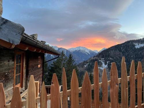 a wooden fence with a view of a mountain at Chalet Larchrast in Larcher