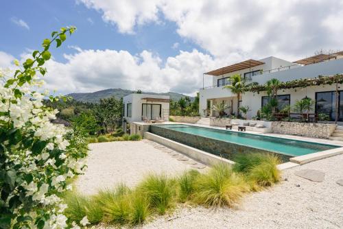 a villa with a swimming pool and a house at Cliffside Haven in Nusa Penida in Nusa Penida