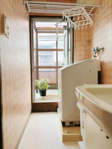 a bathroom with a sink and a window at Direct to Shinjuku 15 mins Up to 6Guests in Tokyo