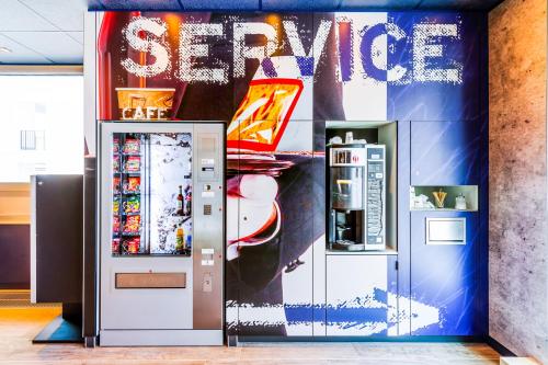 an image of two soda machines in a store at ibis Budget Courbevoie Paris La Défense in Courbevoie