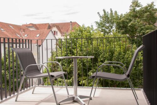 a pair of chairs and a table on a balcony at Hotel Traube Garni in Küttigen