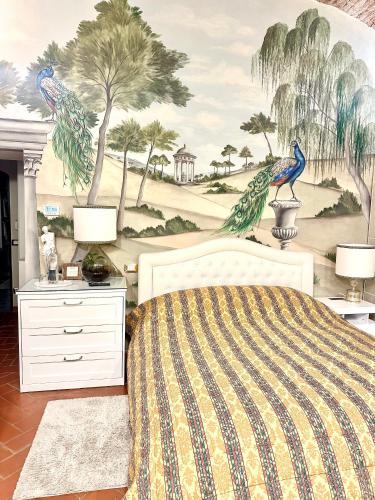 a bedroom with a bed and a wall with a mural at Elegante bilocale / Elegant Double Room in Fiesole