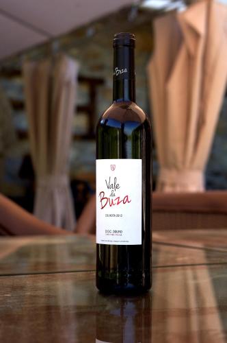 a bottle of red wine sitting on a table at Casa da Quinta do Porto in Lamego