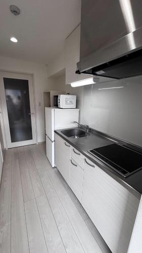 a kitchen with a sink and a counter top at U&T V-Five Room-505 in Beppu