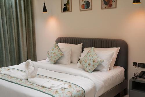 a bedroom with a bed with two white pillows at Hotel ARCHWAY By SOMU'S PRIMS in Jaipur