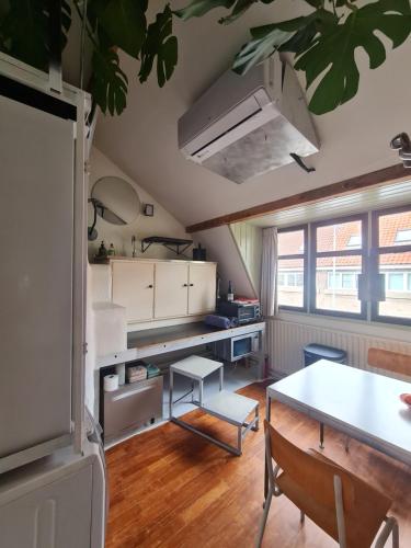 a kitchen with a table and a dining room at the home of the gnome in Eindhoven