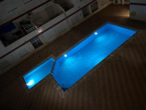 an overhead view of a swimming pool at night at Parque De Las Naciones Dragon con garaje ! in Torrevieja