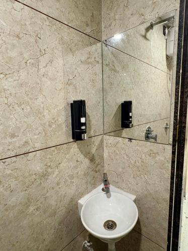 a bathroom with a sink and a shower at Aesthetic 1BHK Elite, Indore in Indore