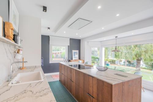 a large kitchen with a sink and a large window at Errekaondo - baskeyrentals in Plentzia