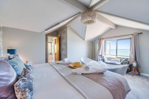 a bedroom with a large bed and a bathtub at Lightkeepers Cottage in Charlestown