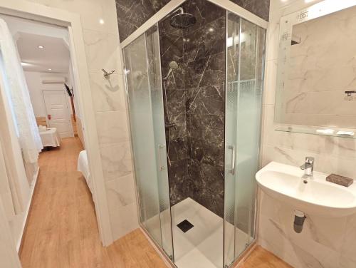 a bathroom with a shower and a sink at Hostal Aliste in Madrid