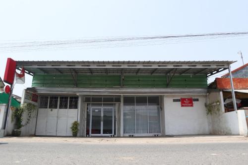a building with a green and white facade at House of A Syariah Sukarame in Tanjungkarang