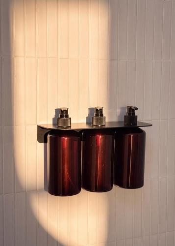 a group of pots hanging on a wall at Prana Ubud in Tegalalang