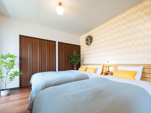 two beds in a hotel room with two at NicoRoom601-Convenient location in Takamatsu