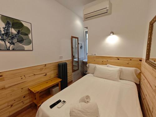 a bedroom with a bed and a mirror at Hostal Aliste in Madrid