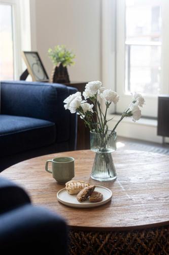 a vase of flowers and cookies on a coffee table at Riverstone Retreat in Golden BC in Golden