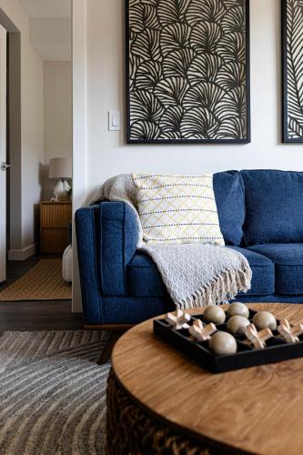 a living room with a blue couch and a table at Riverstone Retreat in Golden BC in Golden