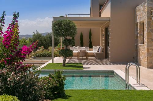 a house with a swimming pool in a yard at Villa Ianira in Kolymvari