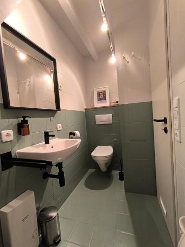 a bathroom with a sink and a toilet at Waldnest Eifel in Kerschenbach