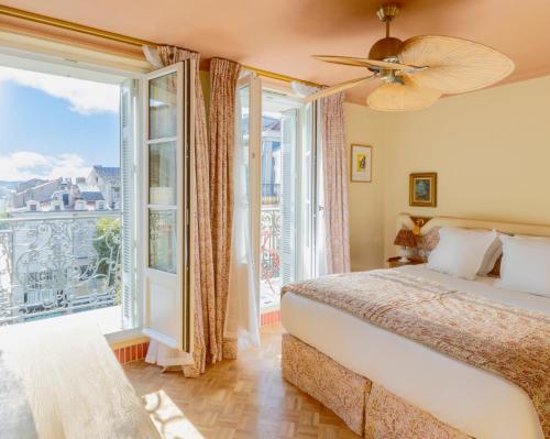 a bedroom with a bed and a large window at Hôtel Amista Marseille in Marseille