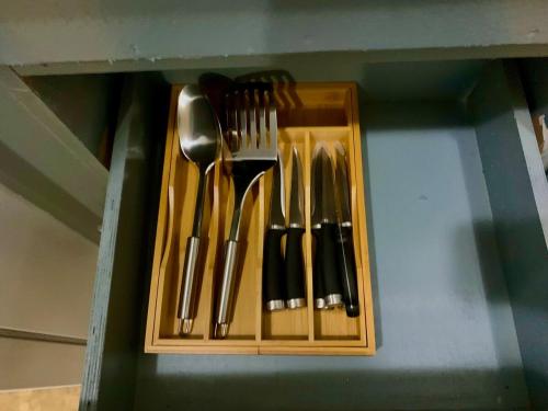 a group of utensils in a wooden holder at Peaceful 1-bedrm, 1-bathrm villa Pedro's Height in Tumon