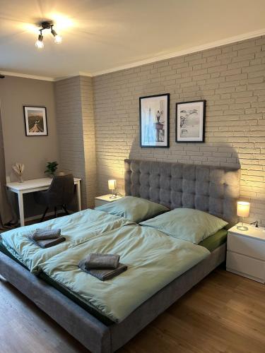 a bedroom with a large bed with a brick wall at Ferienwohnung Hodenhagen in Hodenhagen
