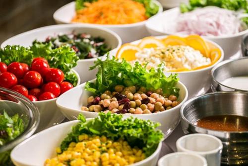 a table topped with bowls of different types of food at Hotel New Nagasaki in Nagasaki