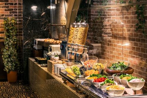 a buffet with many bowls of food on a counter at Hotel New Nagasaki in Nagasaki