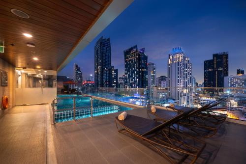 a balcony with a view of a city skyline at Adelphi Suites Bangkok in Bangkok
